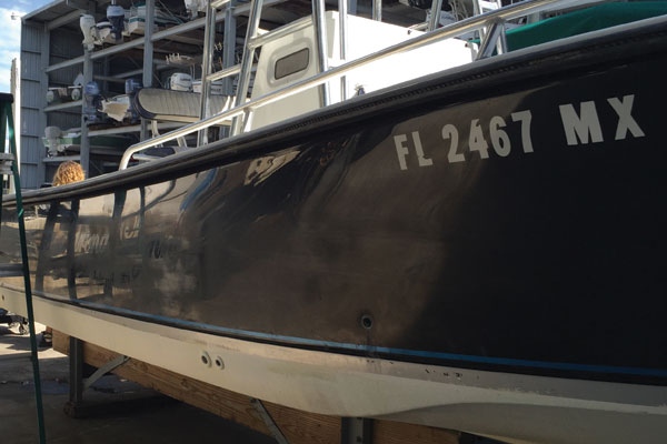 Faded and oxidized black color of starboard hull