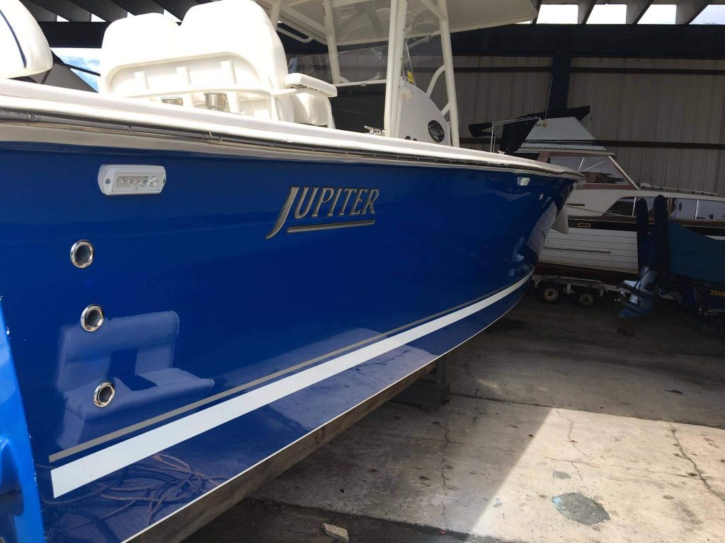 Starboard of blue hulled Jupiter after Glidecoat professional boat detailing and ceramic coating application