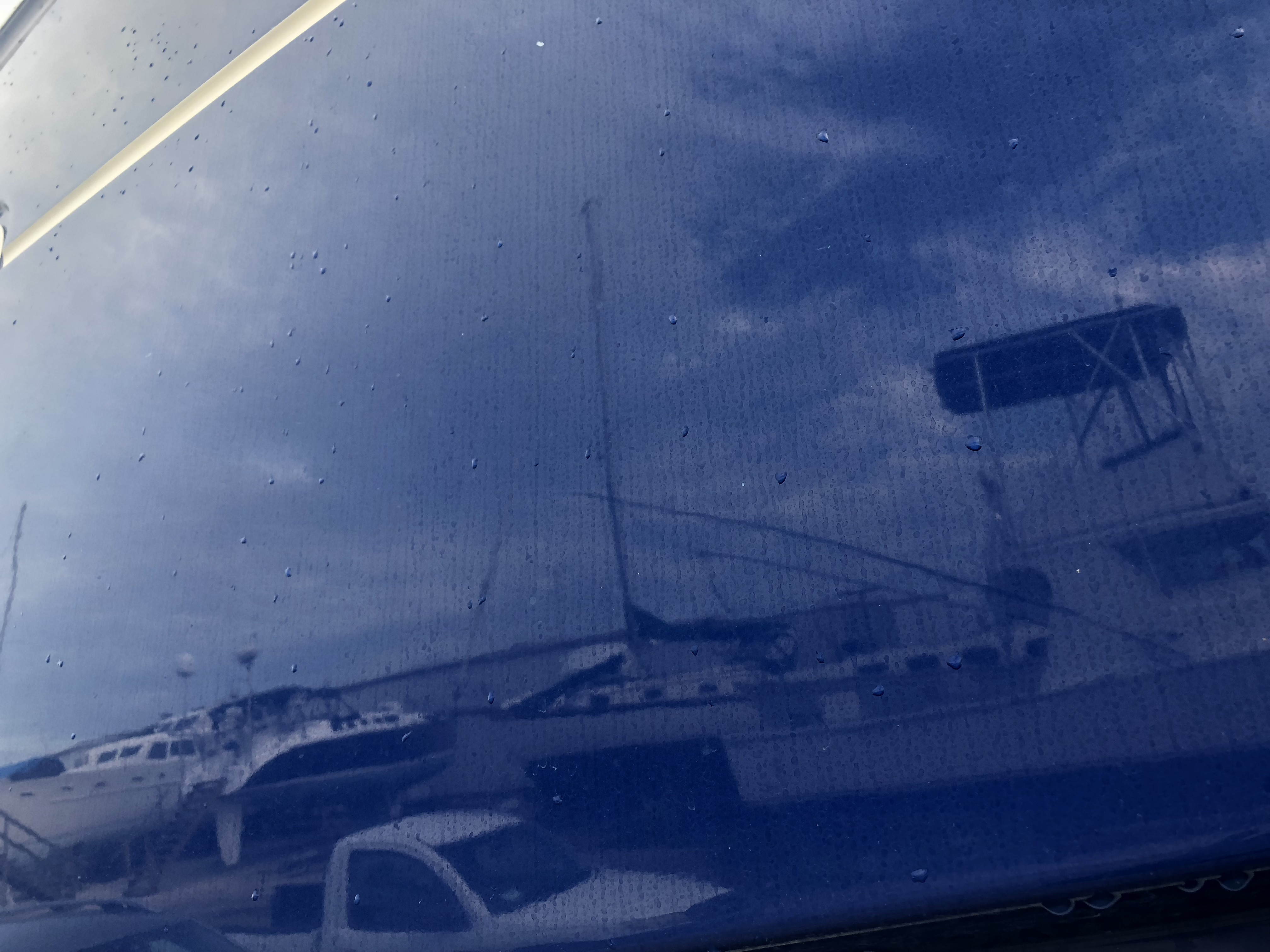 Water marks on blue hull of 43 Powercat before Glidecoat boat detailing
