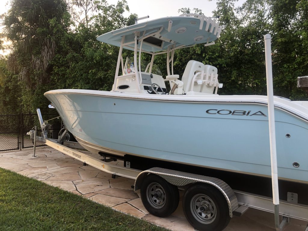 27' Cobia with baby blue hull on a trailer after Glidecoat marine fiberglass top coating application