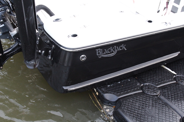 The starboard of a Blackjack 224 sitting on a floating dock