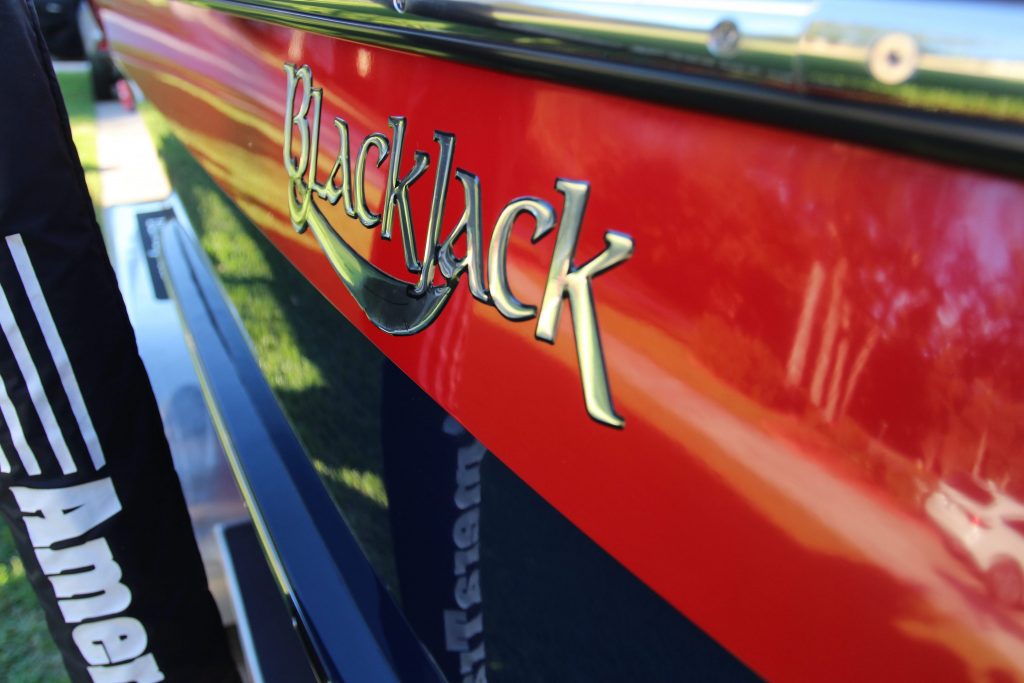 Blackjack logo on black and red hull boat after Glidecoat ceramic boating coating application