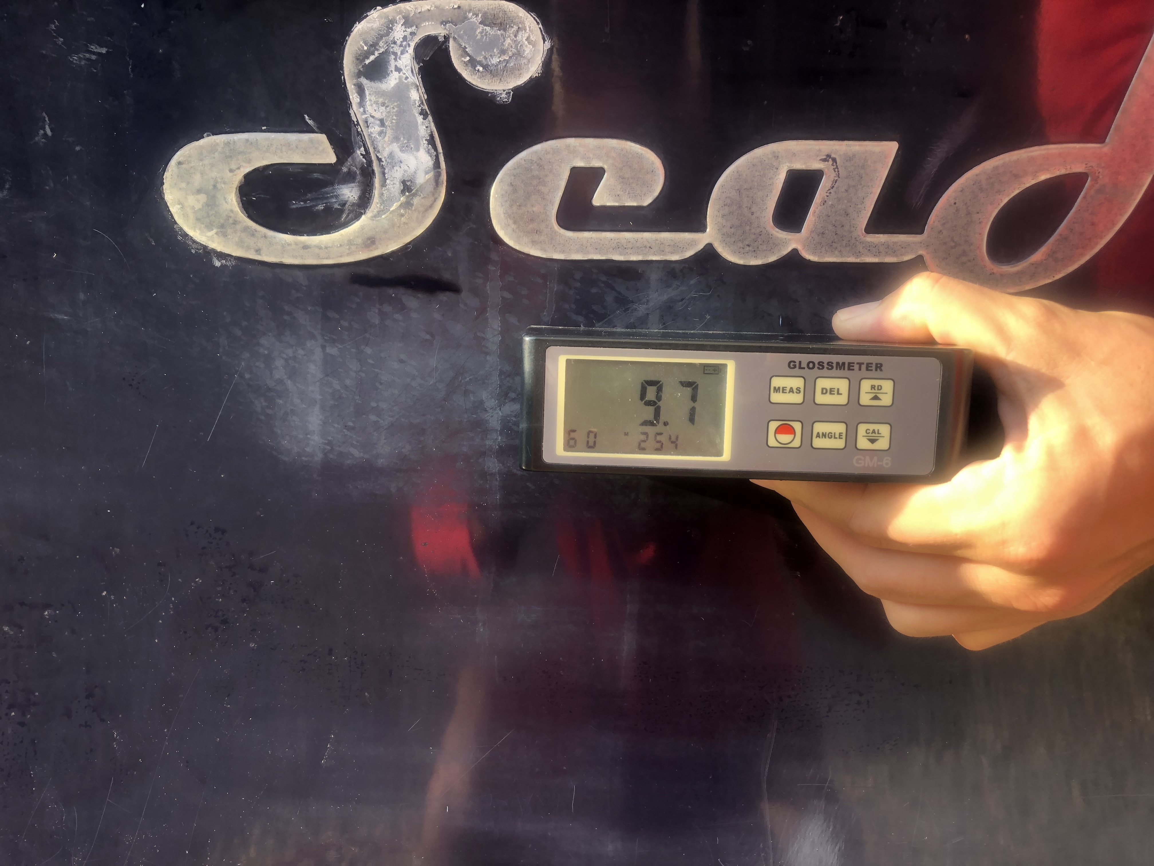 9.7 gloss meter reading on dark blue hull of SeaHunter boat