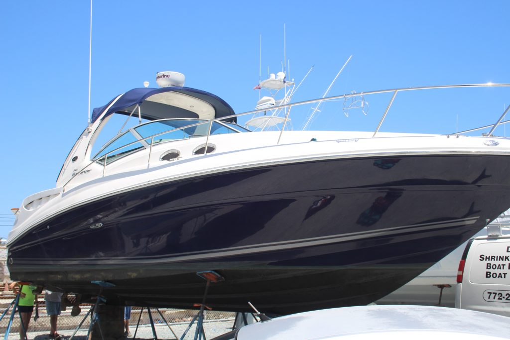 Applying ceramic to 320 Sea Ray Sundancer in yard