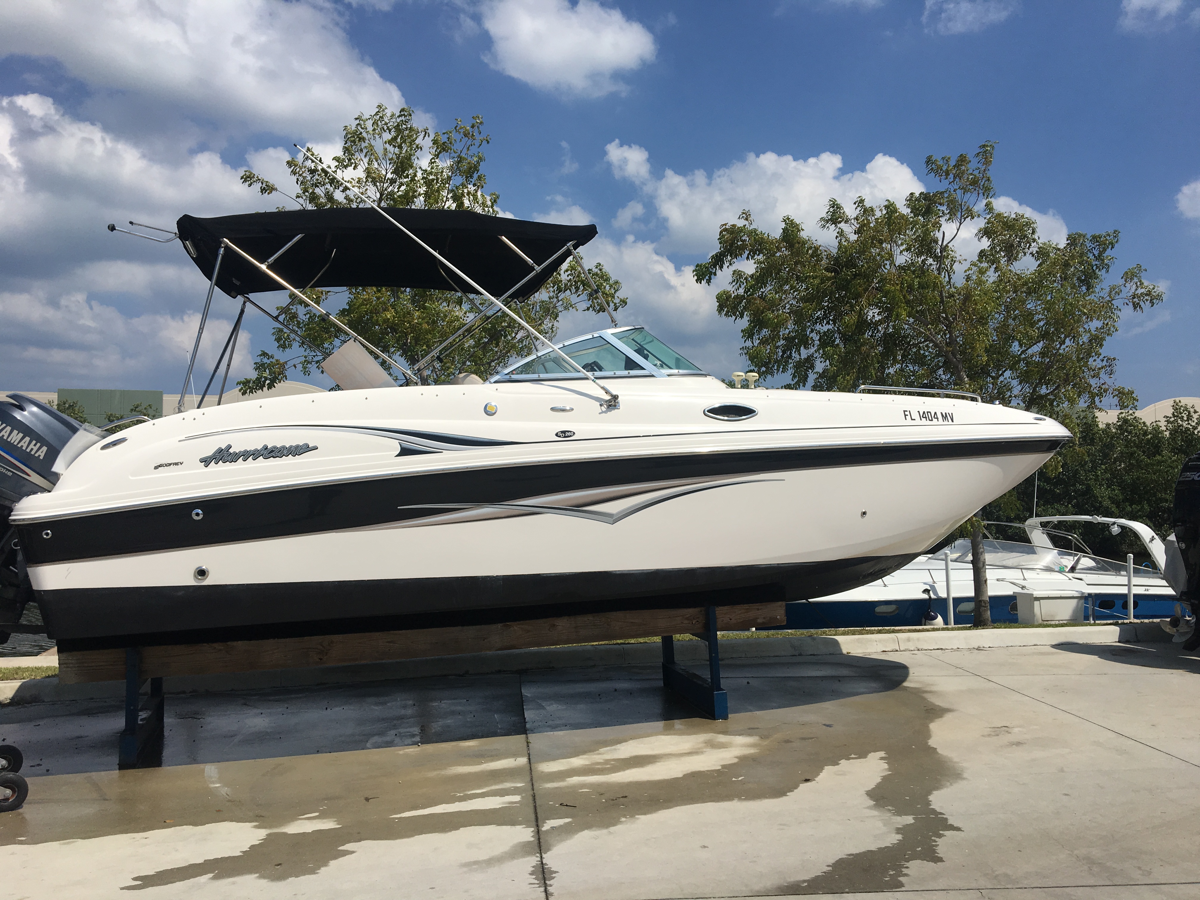 Starboard side of 2011 Hurricane boat sitting in a yard