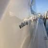 Starboard of viking sitting in the water at a marina with reflection off the surface after Glidecoat yacht ceramic coating application